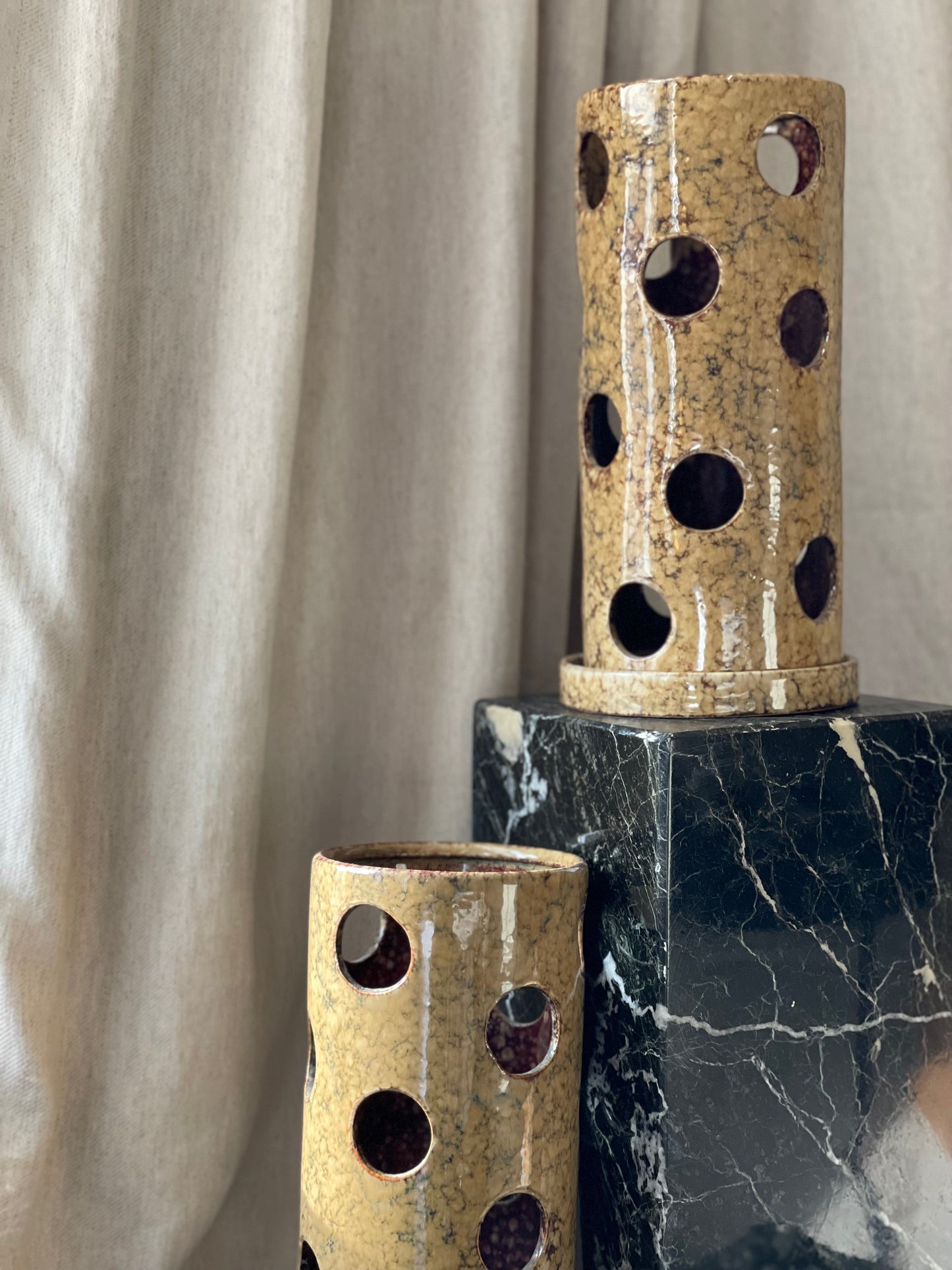 A large pair of ceramic tea light holders
