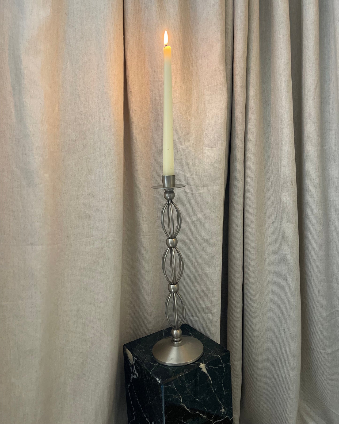 Decorative curtain rod with finial on a curtain background