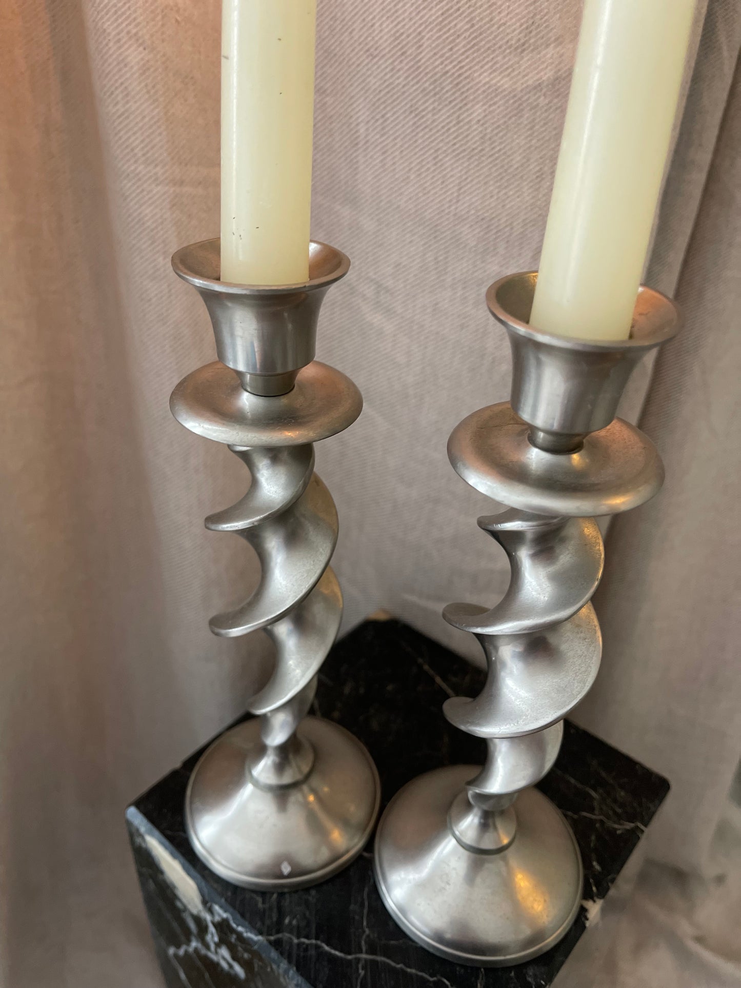 A pair of twisted silvertone candlesticks