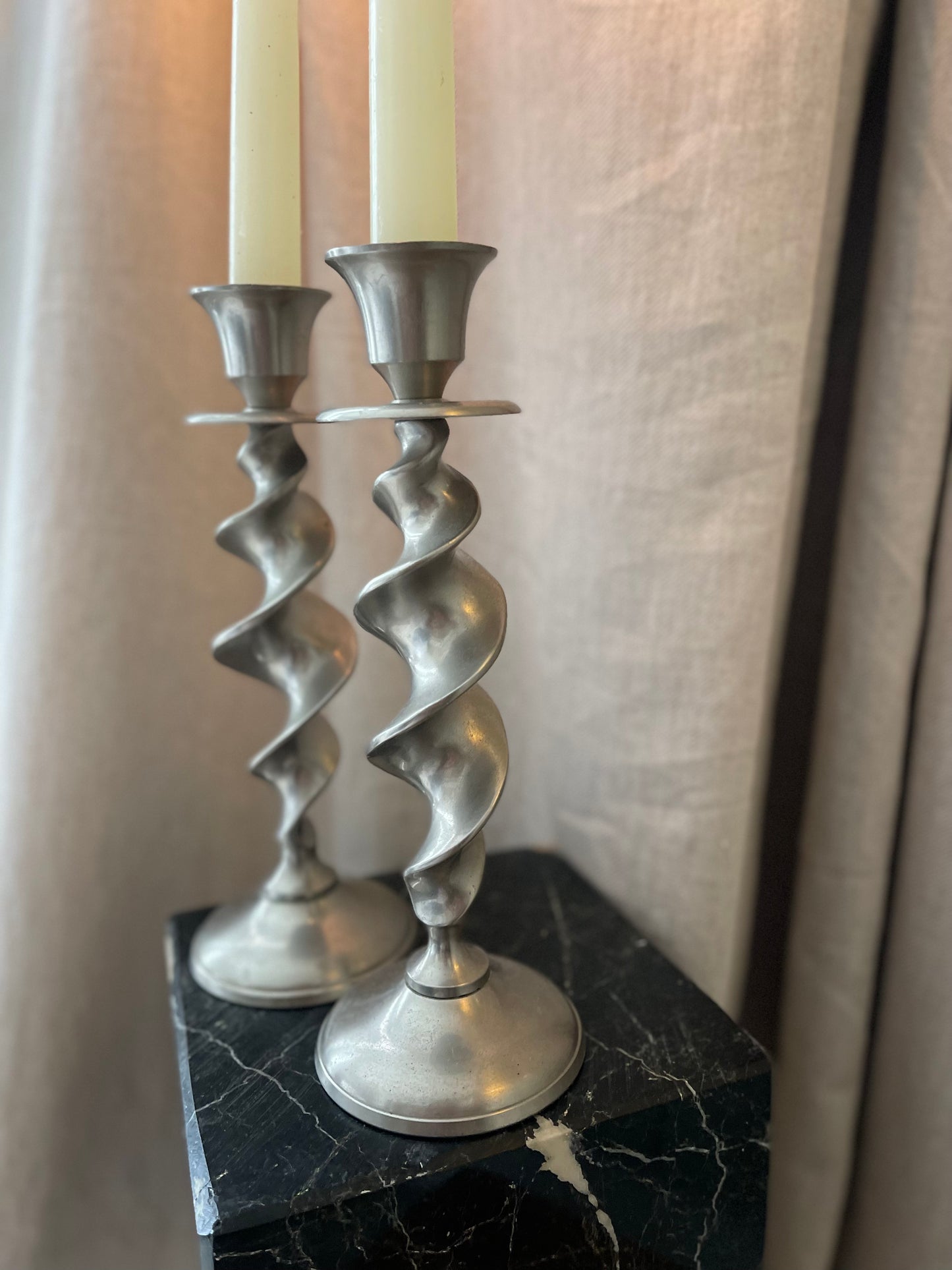 A pair of twisted silvertone candlesticks