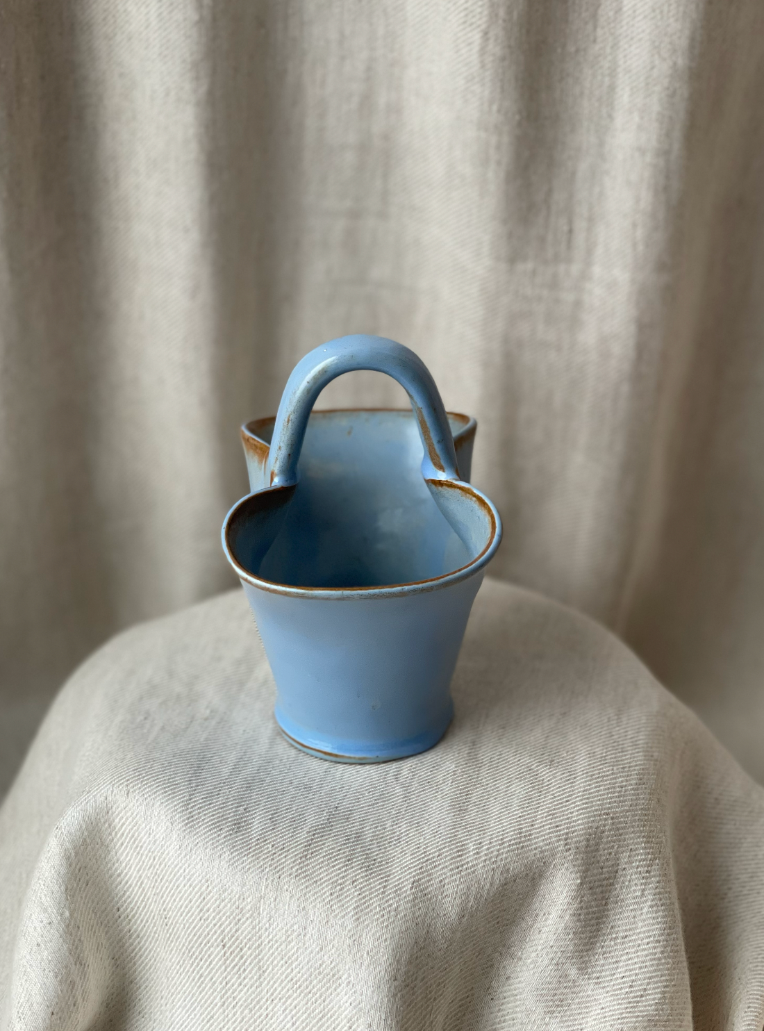 Blue ceramic handbag style basket holder