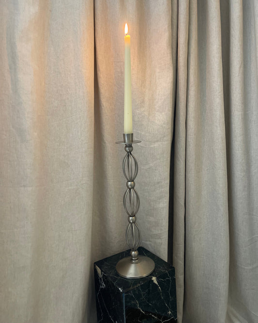 Decorative curtain rod with finial on a curtain background