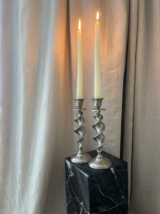 A pair of twisted silvertone candlesticks