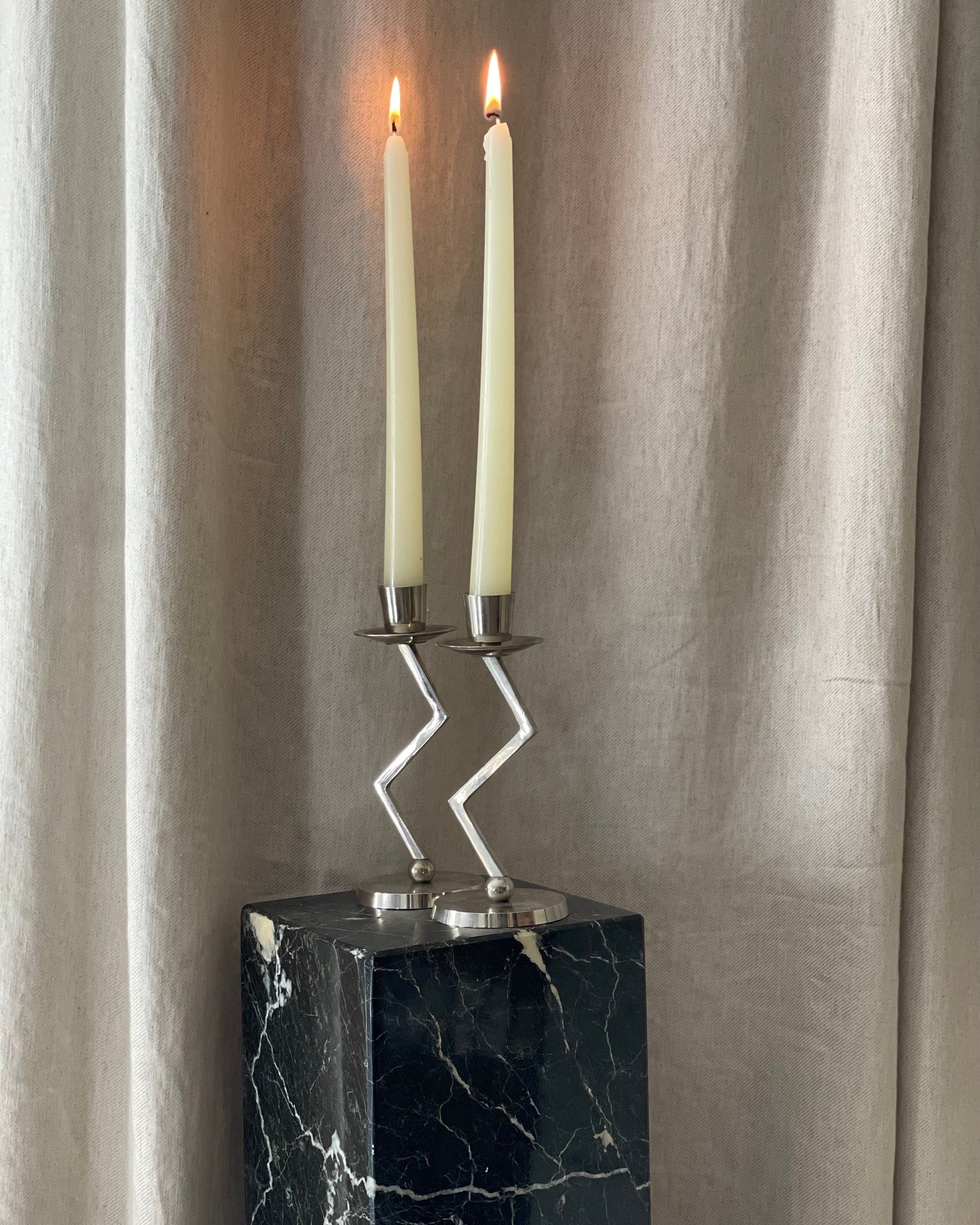 A pair of chrome Memphis zig zag candlesticks