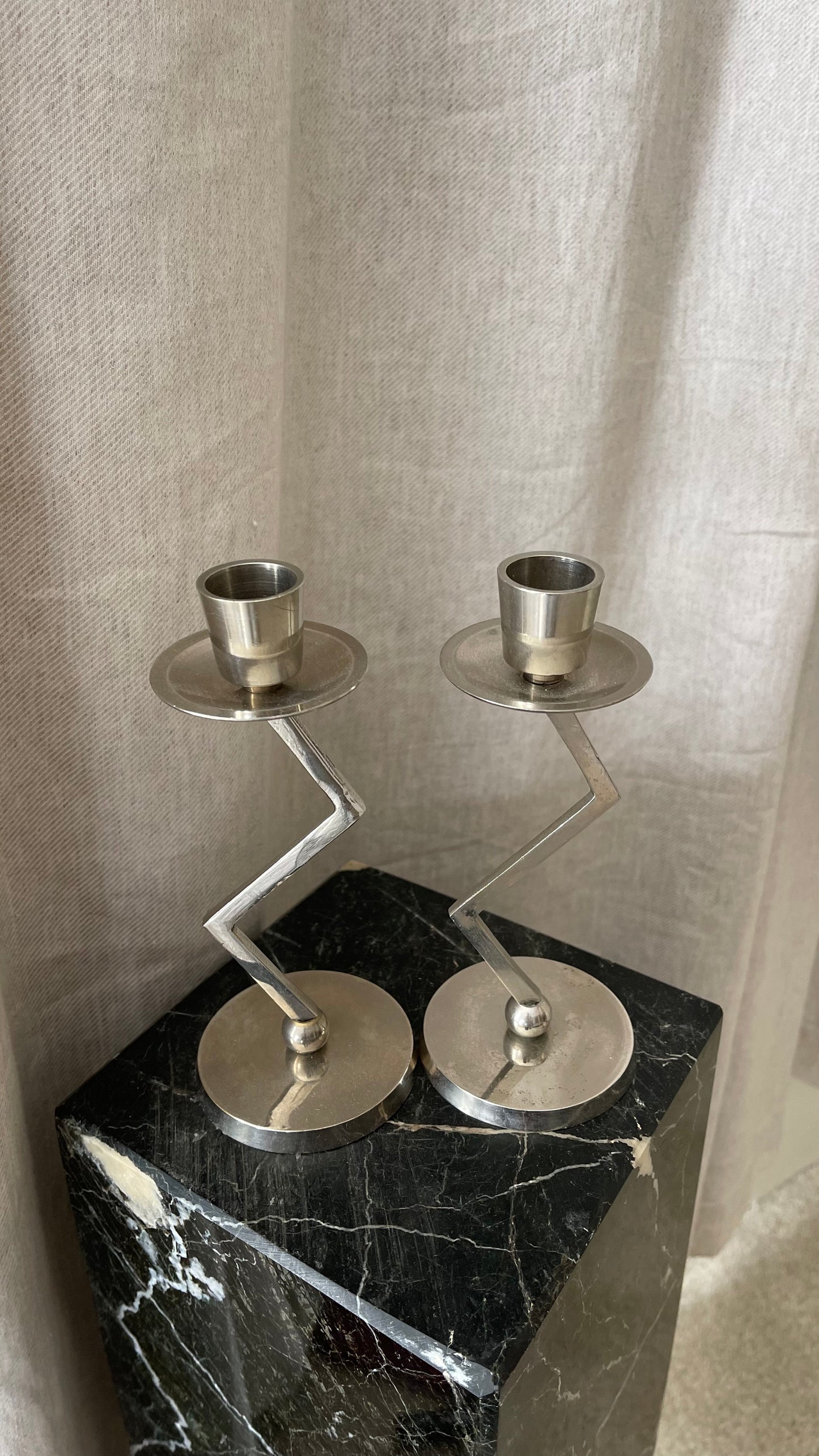 A pair of chrome Memphis zig zag candlesticks